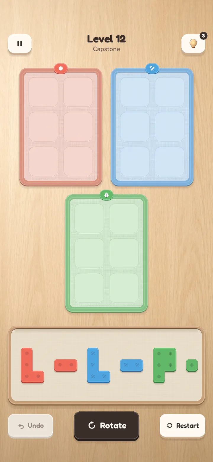 Level 12 'Capstone': coral, blue and green mats with a tray of L, I, domino and P-shaped tiles.